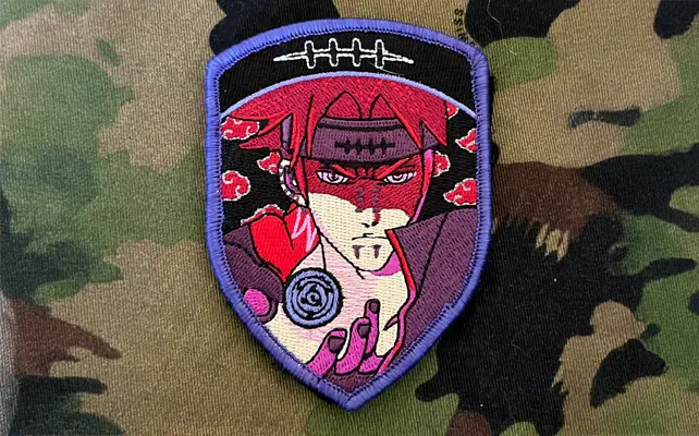 Zugbadge ricamato con ninja anime in stile rosso, gesto della mano e simbolo, patch militare su tessuto mimetico.